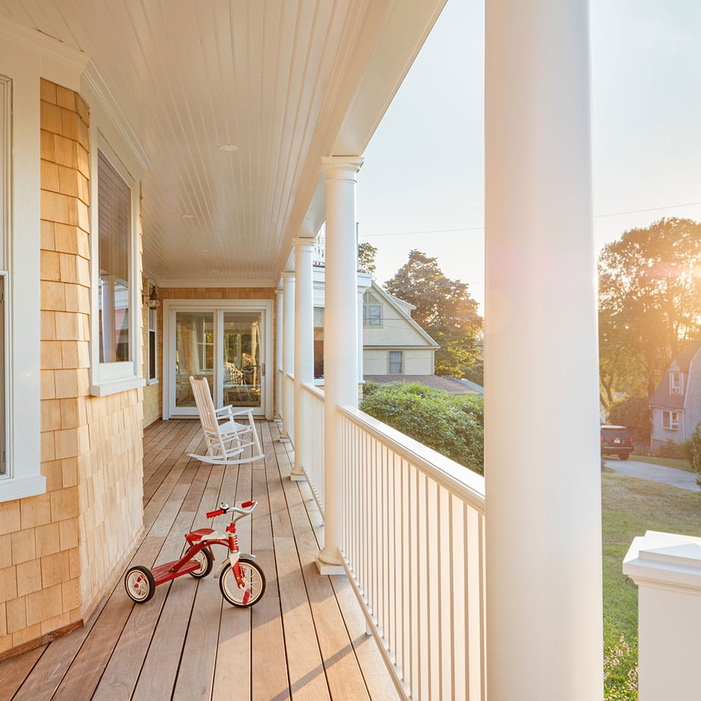 House porch with white railings and rocking chairs