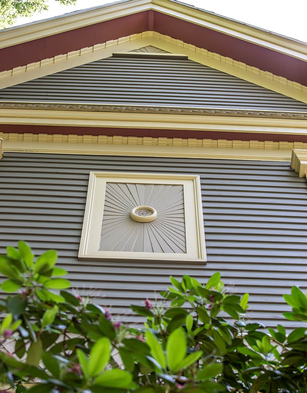 Decorative exterior window and trim of blue and red house