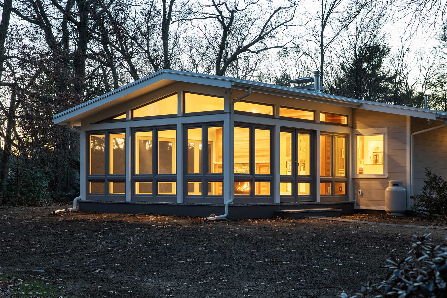Exterior of single story home under construction with sunroom