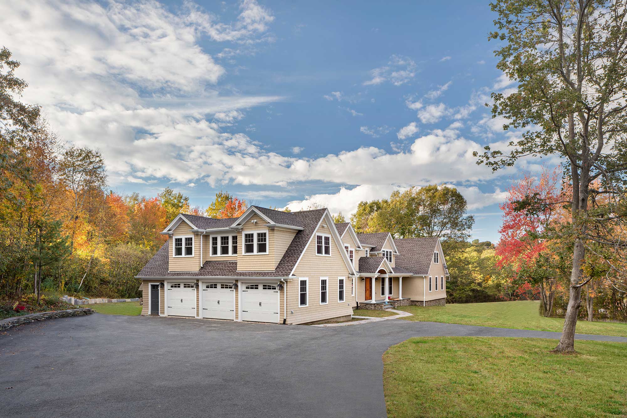 Large two-story beige house with 3-car garage