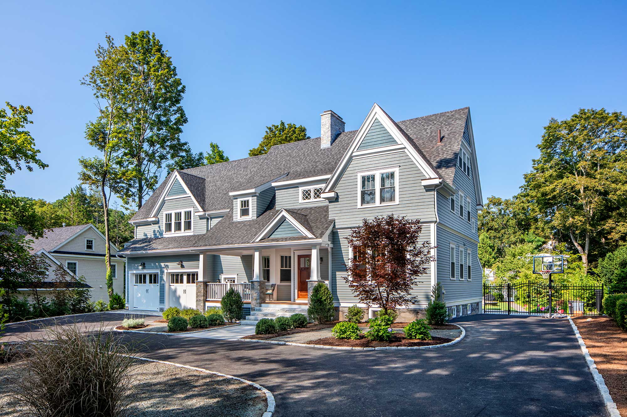 Two-story light blue home with two-car garage